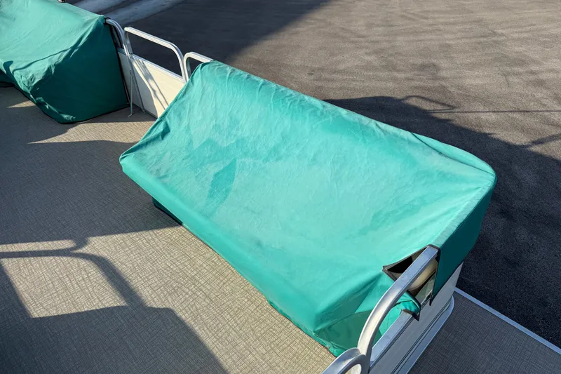 Slide: The Image of Covered seating on a 1998 Lowe Family 245 pontoon boat, teal fabric. - 23