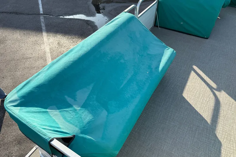 Slide: The Image of Teal-covered seat on 1998 Lowe Family 245 boat deck. - 24