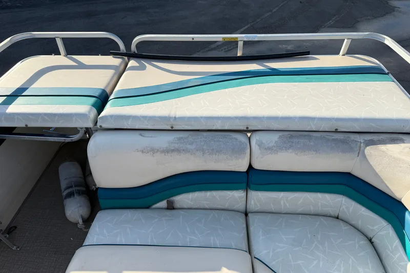 Slide: The Image of 1998 Lowe Family 245 boat interior with white and teal seating. - 17