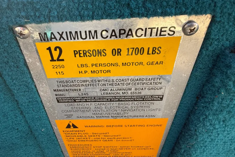 Slide: The Image of Capacity plate for Lowe Family 245 boat, 1998 model, showing maximum capacities and safety information. - 18