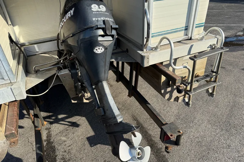 Slide: The Image of Outboard motor on 1998 Lowe Family 245 boat, featuring a Mercury 9.9 ProKicker engine. - 5