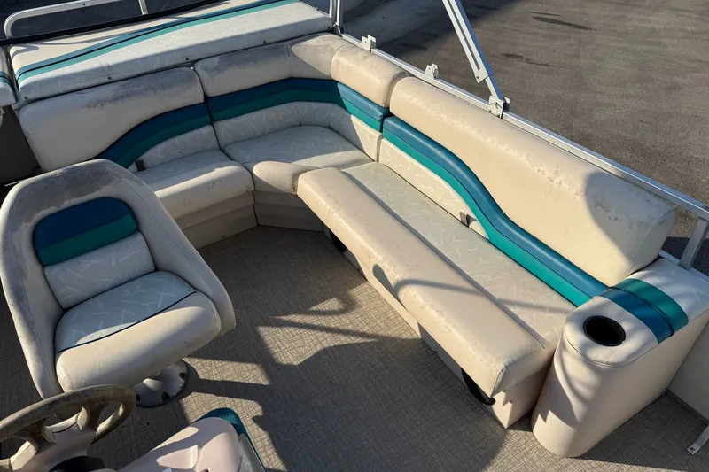 Slide: The Image of 1998 Lowe Family 245 boat interior with white and teal seating arrangement. - 14