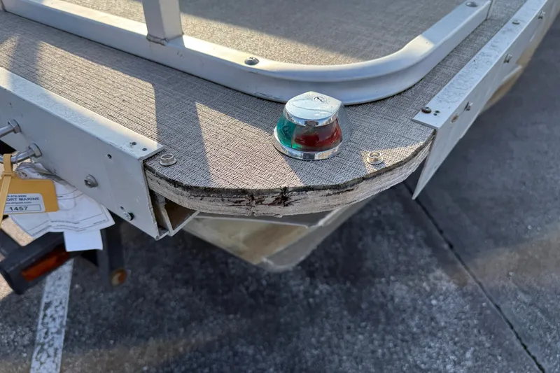 Slide: The Image of 1998 Lowe Family 245 boat with visible wear and navigation light. - 7