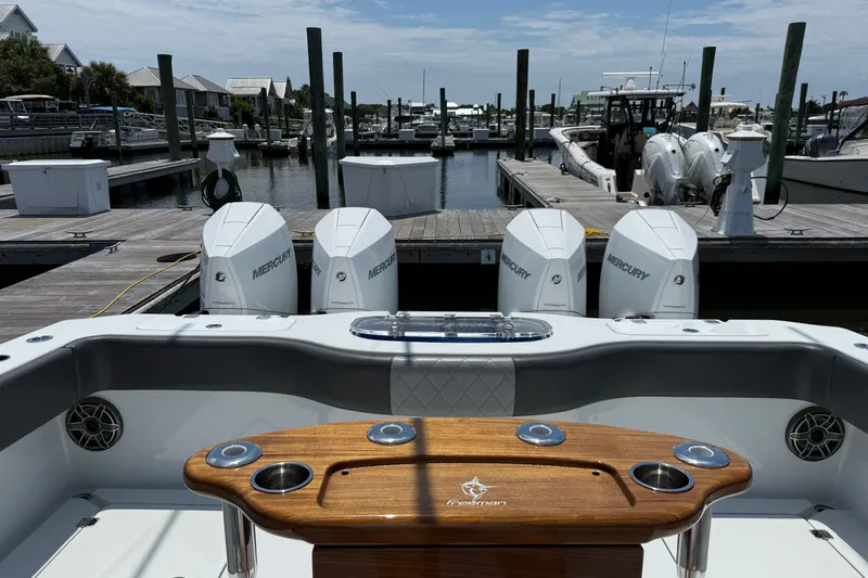 Slide: The Image of 2024 Freeman 38 boat with Mercury engines docked at a marina. - 2
