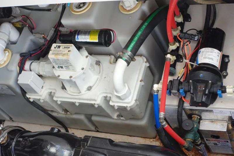 Slide: The Image of Engine compartment of 2013 Sea Ray Sundancer 370 with visible mechanical components and wiring. - 34