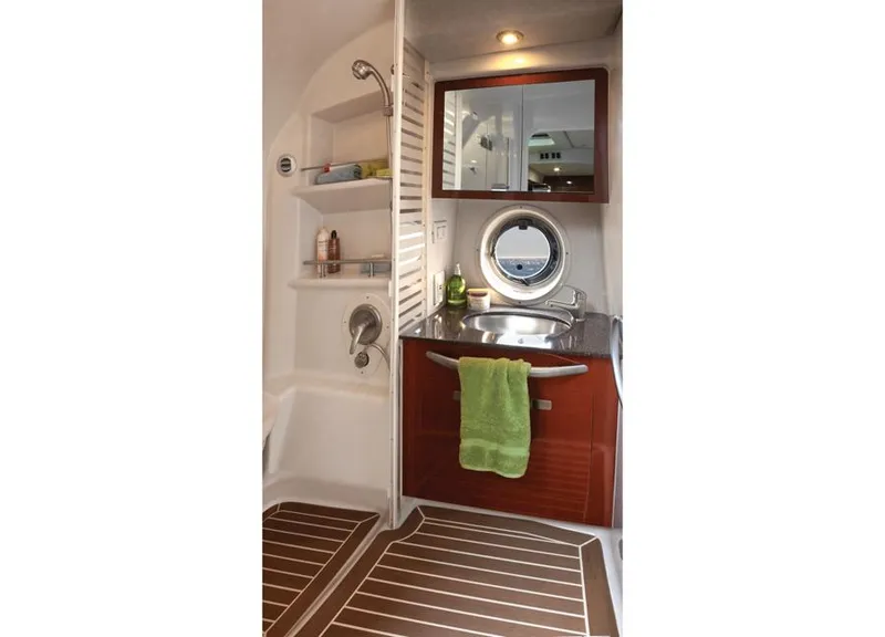 Slide: The Image of Manufacturer Provided Image: 2013 Sea Ray 370 Sundancer bathroom with sink, shower, and porthole window. - 31