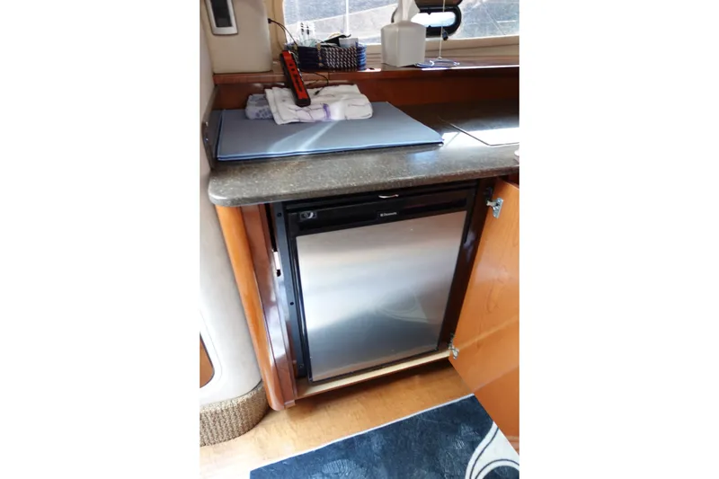 Slide: The Image of Compact kitchen area in 2013 Sea Ray Sundancer 370 yacht with stainless steel fridge. - 24