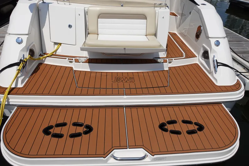 Slide: The Image of 2013 Sea Ray Sundancer 370 boat deck with teak flooring and cushioned seating. - 5