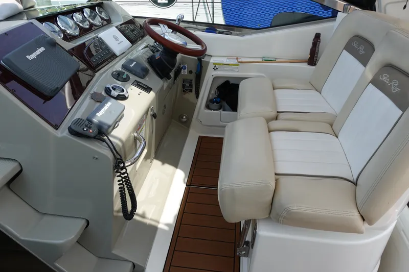 Slide: The Image of Cockpit of 2013 Sea Ray Sundancer 370 with dual seats and navigation controls. - 10