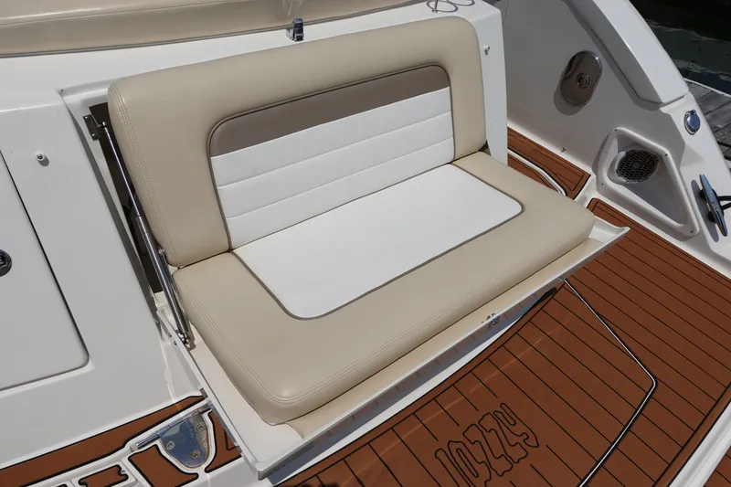 Slide: The Image of 2013 Sea Ray Sundancer 370 boat seat with beige and white upholstery on teak deck. - 6