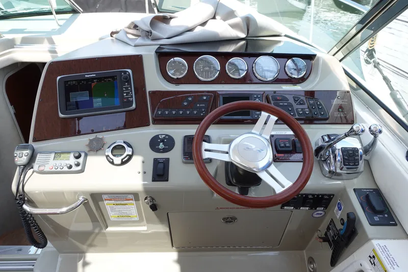 Slide: The Image of Cockpit of 2013 Sea Ray Sundancer 370 with steering wheel and navigation controls. - 8