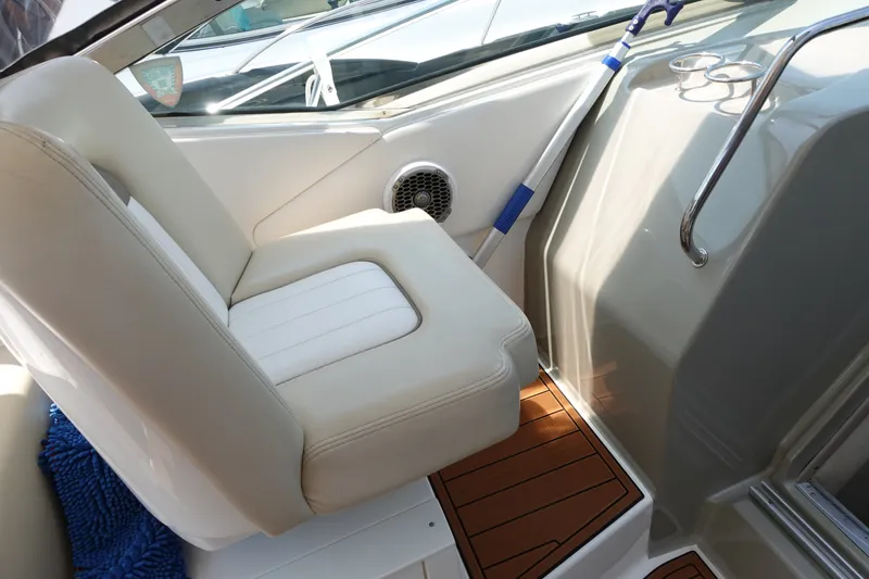 Slide: The Image of Interior seating of 2013 Sea Ray Sundancer 370 boat with white upholstery and wooden flooring. - 12