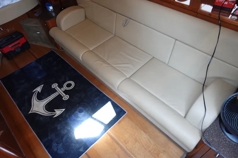 Slide: The Image of Luxurious interior of 2013 Sea Ray Sundancer 370 with beige sofa and anchor-themed rug. - 21