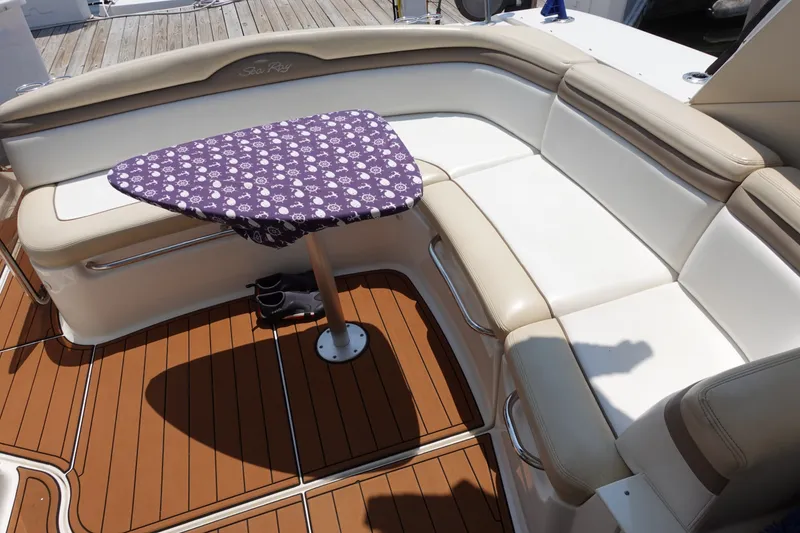 Slide: The Image of Luxurious seating area on a 2013 Sea Ray Sundancer 370 yacht with a patterned table cover. - 15