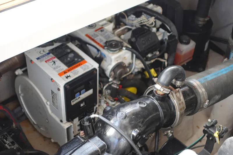 Slide: The Image of Engine compartment of a 2013 Sea Ray Sundancer 370, showcasing mechanical components and wiring. - 33