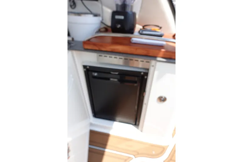 Slide: The Image of Compact kitchenette on 2013 Sea Ray Sundancer 370 yacht with fridge and wooden countertop. - 19