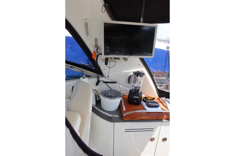 Slide: The Image of Interior of 2013 Sea Ray Sundancer 370 with TV, blender, and seating area. - 18