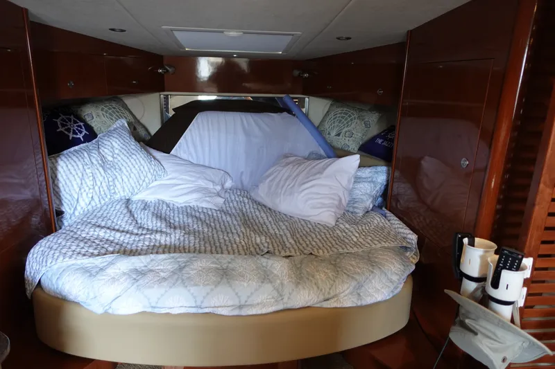 Slide: The Image of Cozy cabin interior of 2013 Sea Ray Sundancer 370 with plush bedding and wooden accents. - 28