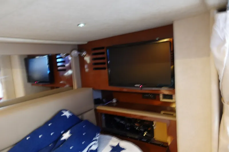 Slide: The Image of Interior of 2013 Sea Ray Sundancer 370 with TV and cozy bedding. - 29