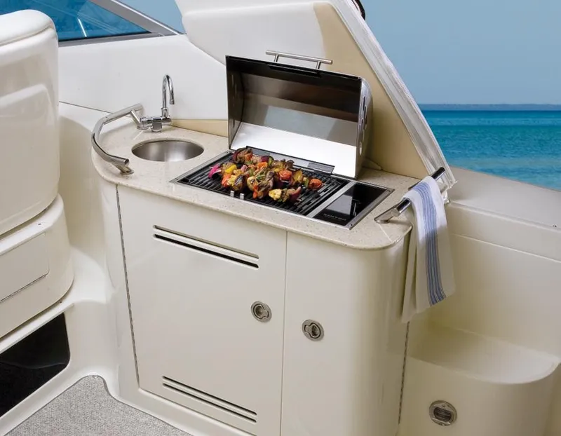 Slide: The Image of Manufacturer Provided Image: Outdoor grill and sink on 2013 Sea Ray 370 Sundancer yacht with ocean view. - 17