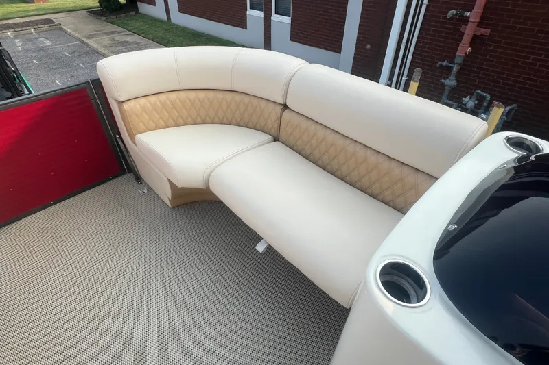 Slide: The Image of Luxurious seating on a 2020 Lexington 521 boat, featuring cream upholstery and cup holders. - 18