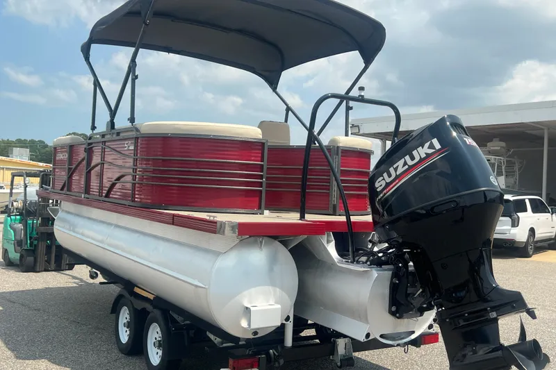 Slide: The Image of 2020 Lexington 521 pontoon boat with Suzuki outboard motor on trailer. - 31