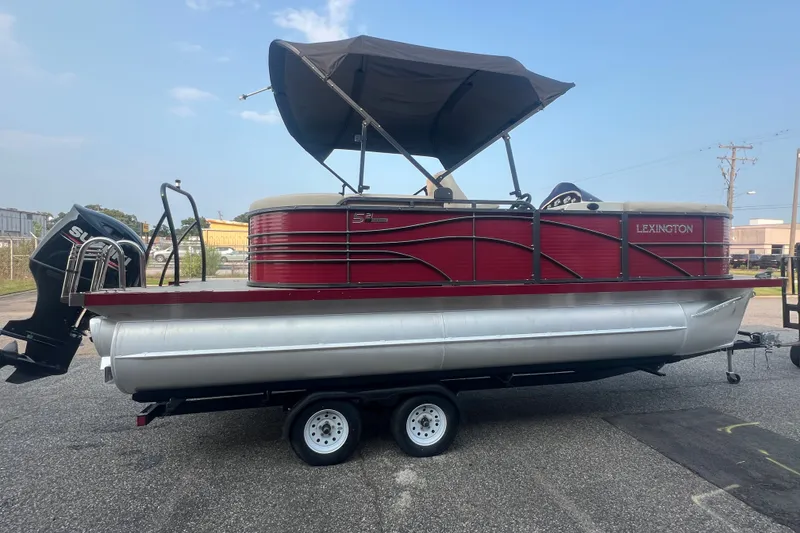 Slide: The Image of 2020 Lexington 521 pontoon boat with canopy on trailer, side view. - 7