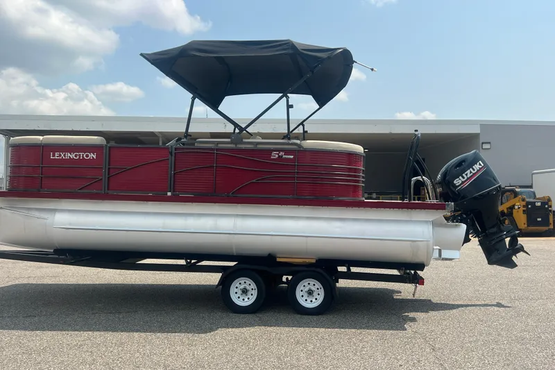 Slide: The Image of 2020 Lexington 521 pontoon boat with Suzuki outboard motor on trailer. - 33