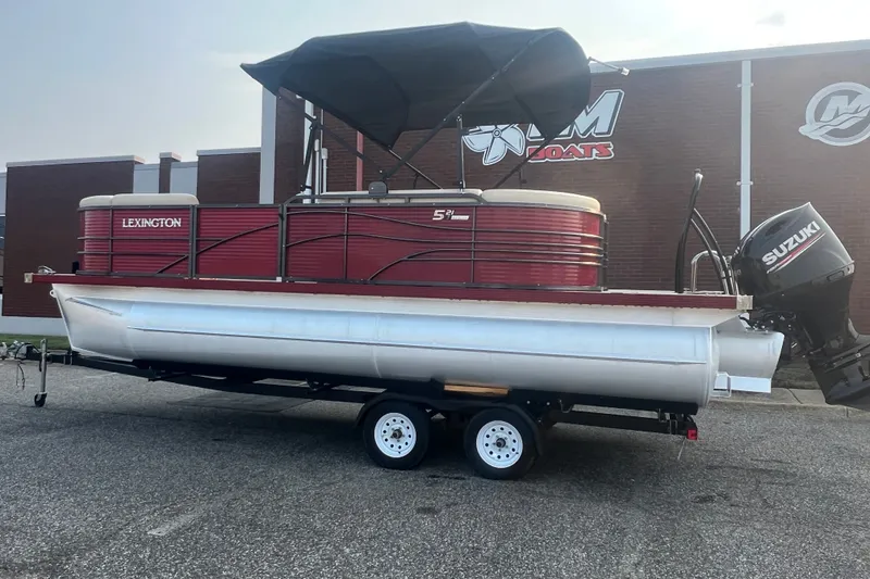 Slide: The Image of 2020 Lexington 521 pontoon boat with Suzuki outboard motor on trailer. - 2