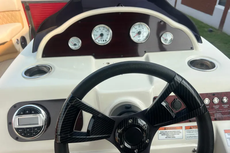 Slide: The Image of Steering console of a 2020 Lexington 521 boat with gauges and controls. - 16