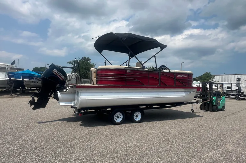 Slide: The Image of 2020 Lexington 521 pontoon boat with Suzuki outboard motor on trailer. - 28