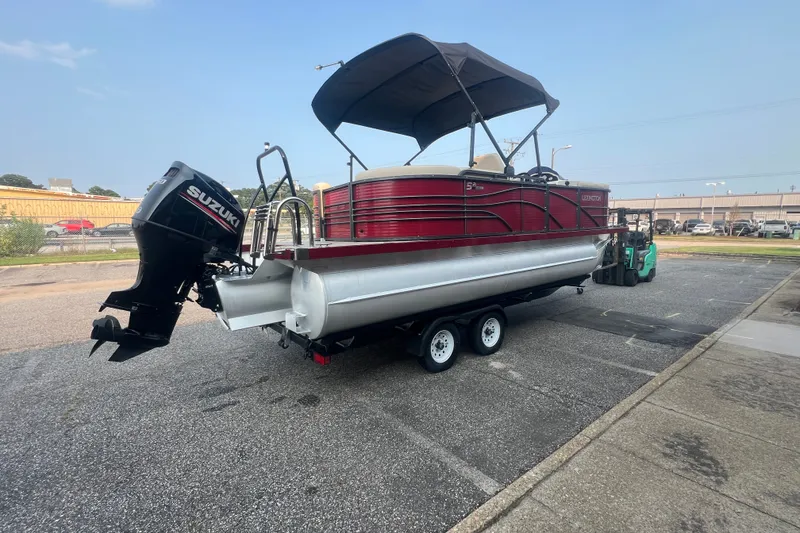 Slide: The Image of 2020 Lexington 521 pontoon boat with Suzuki outboard motor on trailer. - 6