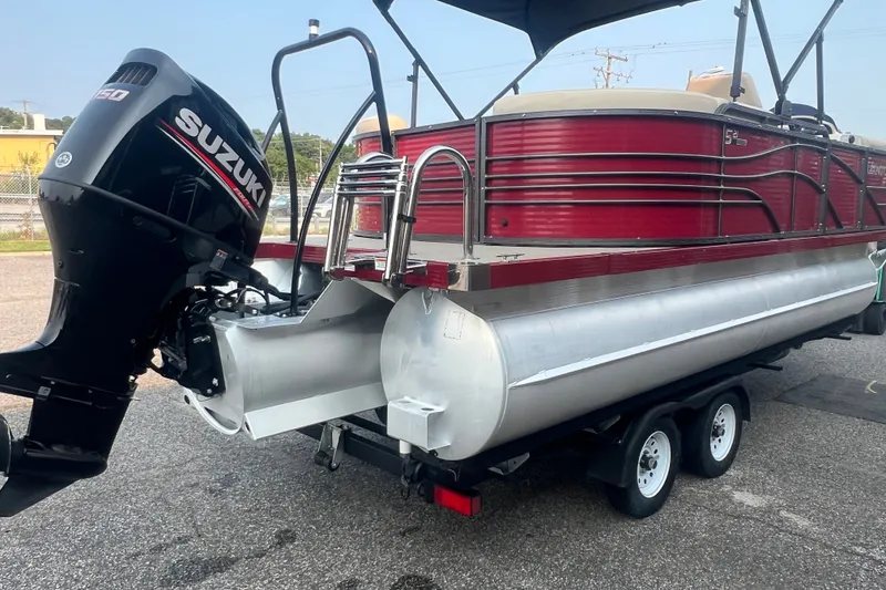 Slide: The Image of 2020 Lexington 521 pontoon boat with Suzuki outboard motor on trailer. - 5