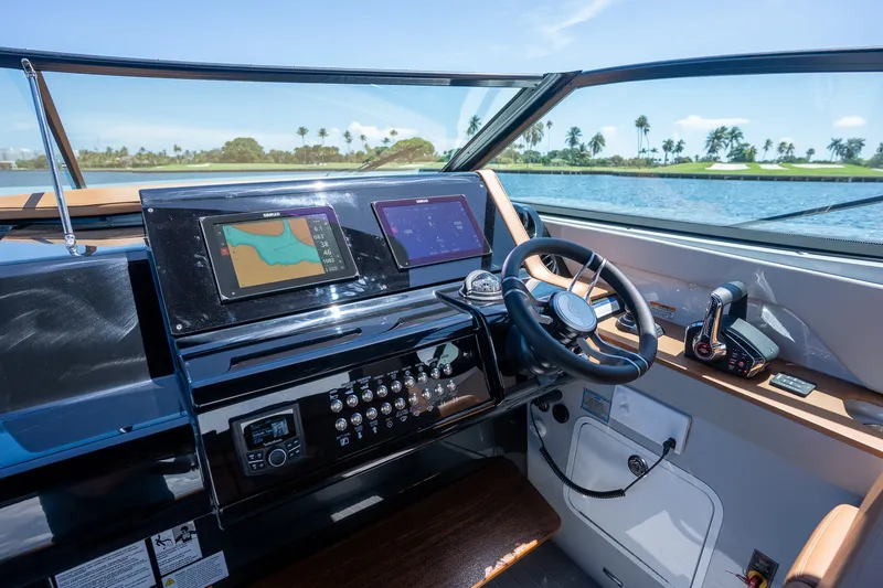 Slide: The Image of The cockpit of the 2027 Cruisers Yachts 38 GLS OB features modern navigation systems and sleek design. - 21