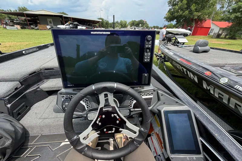 Slide: The Image of 2025 Skeeter FXR21 PRO boat cockpit with advanced Humminbird electronics and steering wheel. - 6
