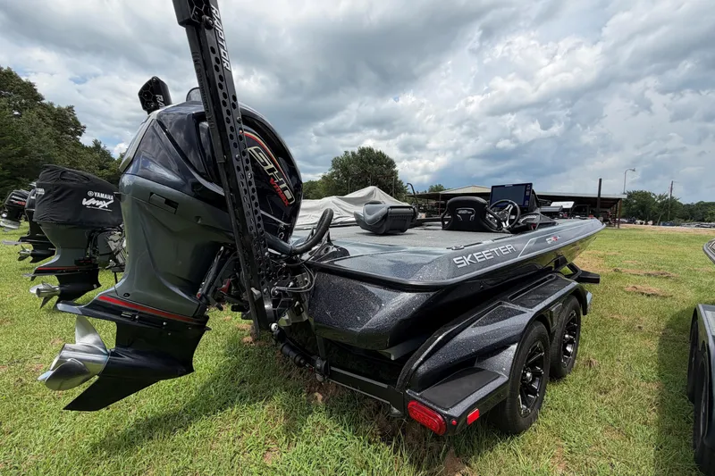 Slide: The Image of 2025 Skeeter FXR21 PRO boat with Yamaha engine on grassy field under cloudy sky. - 8