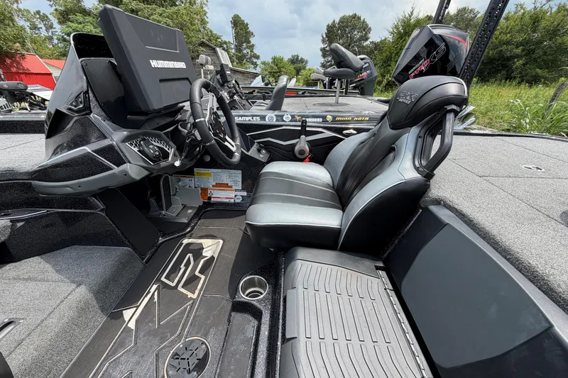 Slide: The Image of 2025 Skeeter FXR21 PRO boat interior with steering wheel and seating. - 5