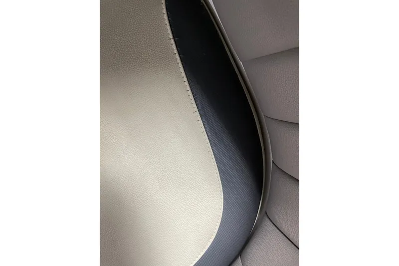 Slide: The Image of Close-up of 2013 Malibu Wakesetter 20 MXZ boat seat upholstery, featuring beige and black textures. - 21