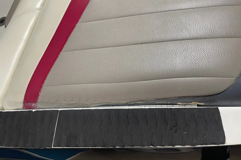 Slide: The Image of Close-up of 2013 Malibu Wakesetter 20 MXZ boat seat with red and gray upholstery. - 25