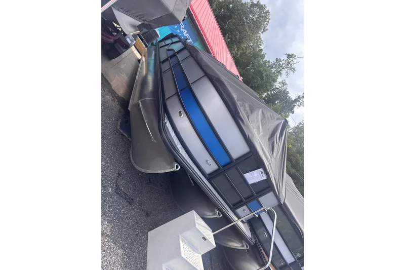The Image of 2027 Bentley Pontoons 223 Swingback covered, parked outdoors, showcasing sleek design and modern features. - 1
