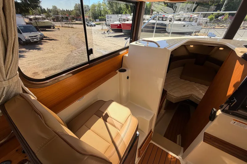 Slide: The Image of Interior of 2022 Ranger Tugs R-27 boat, featuring seating and cabin area. - 13