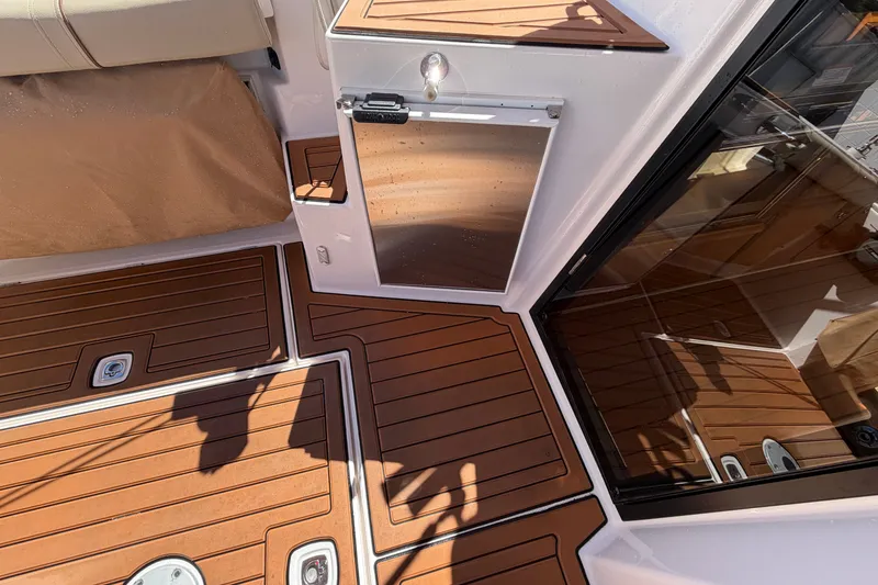 Slide: The Image of 2022 Ranger Tugs R-27 boat interior with teak flooring and sleek design elements. - 8