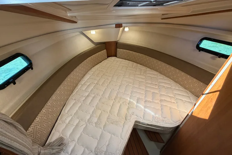 Slide: The Image of Interior cabin of 2022 Ranger Tugs R-27 with cozy bed and ambient lighting. - 17