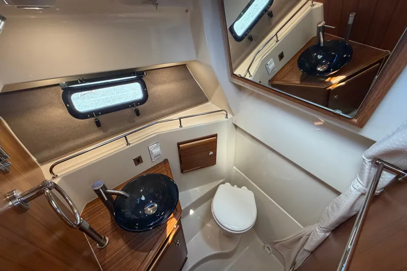 Slide: The Image of 2022 Ranger Tugs R-27 boat bathroom with modern sink and toilet. - 16