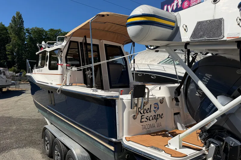 Slide: The Image of 2022 Ranger Tugs R-27 boat, "Reel Escape," docked with Yamaha engine, Tacoma, WA. - 2