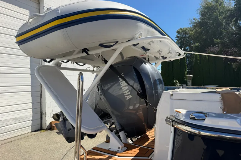 Slide: The Image of 2022 Ranger Tugs R-27 with Yamaha outboard and inflatable boat on deck. - 5