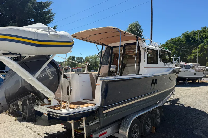 Slide: The Image of 2022 Ranger Tugs R-27 boat on trailer with Yamaha outboard motor and inflatable dinghy. - 3