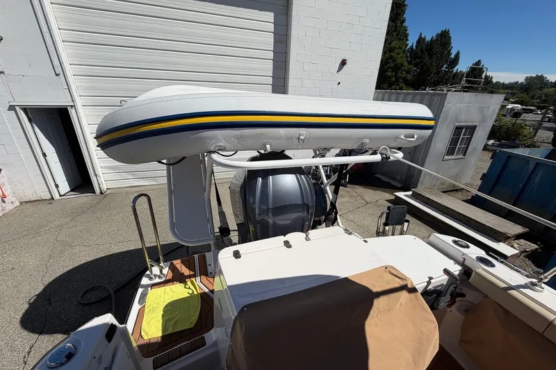 Slide: The Image of 2022 Ranger Tugs R-27 boat with mounted inflatable dinghy on deck. - 6