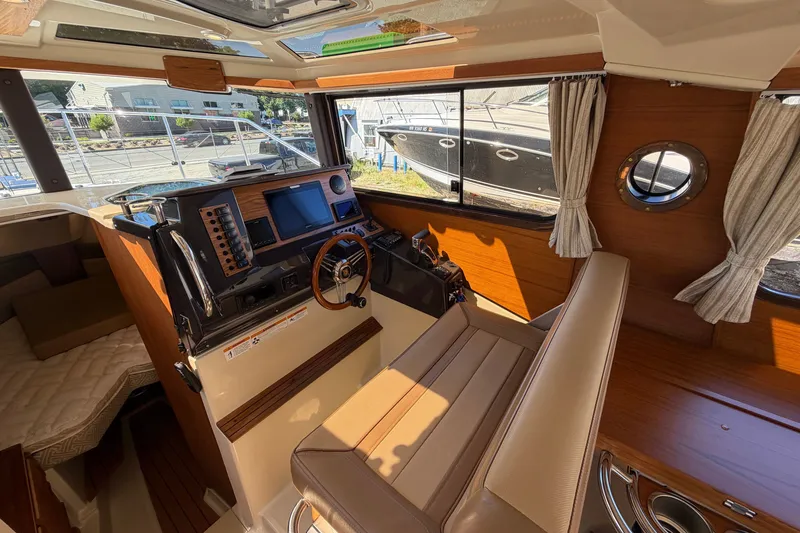 Slide: The Image of Interior of 2022 Ranger Tugs R-27 boat with helm, seating, and navigation equipment. - 15