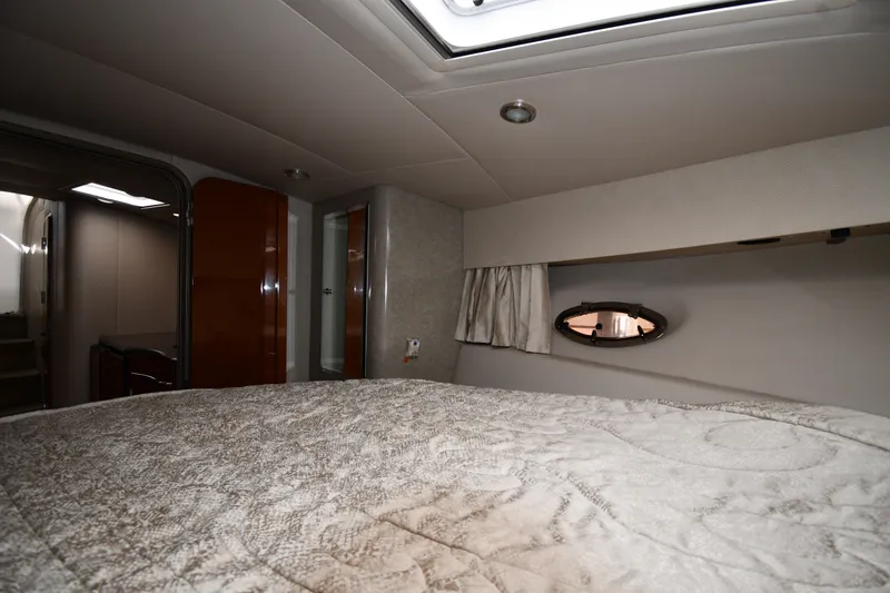 Slide: The Image of Interior cabin of a 2006 Formula 40 Performance Cruiser, featuring a cozy bed and porthole window. - 32